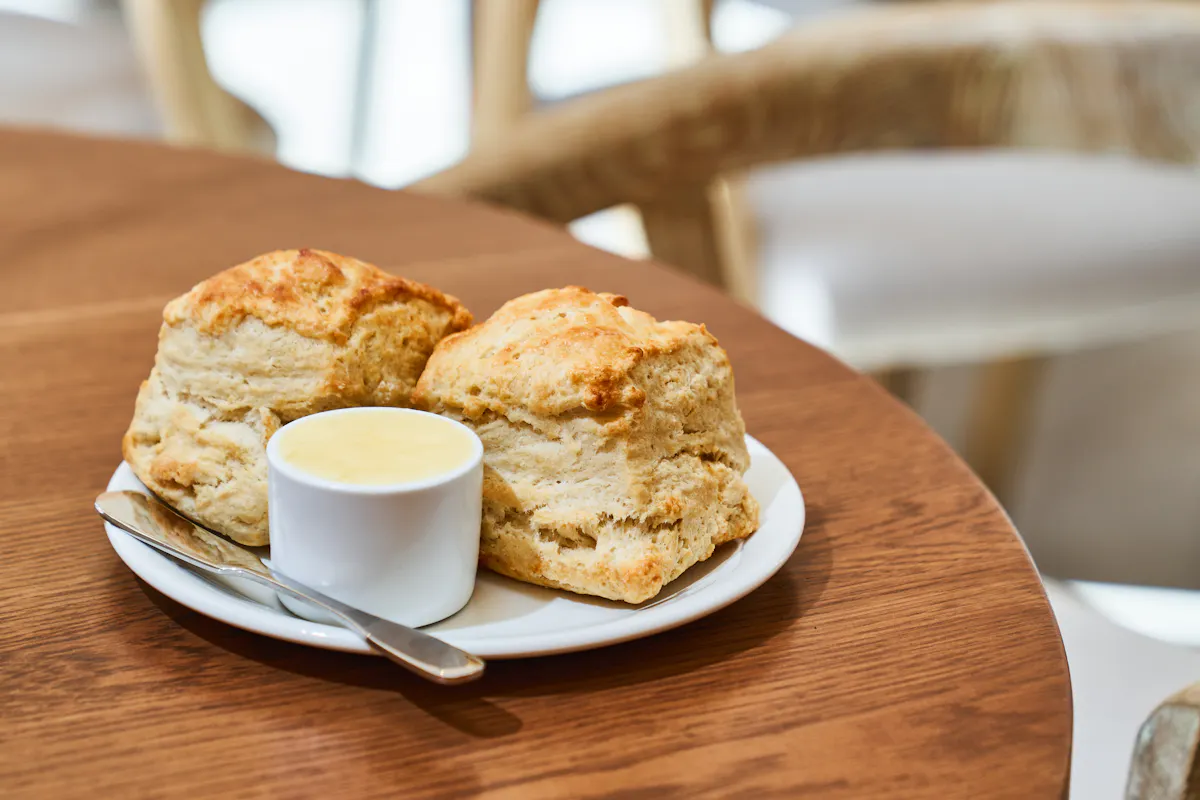 a close up of a plate of food and a cup of coffee